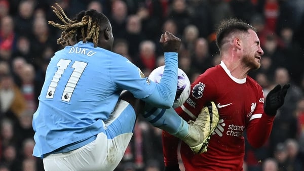 Liverpool had a penalty shout after a high foot from Jeremy Doku (L) caught Alexis Mac Allister