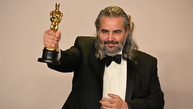 Hoyte van Hoytema poses in the press room with the Oscar for Best Cinematography for Oppenheimer
