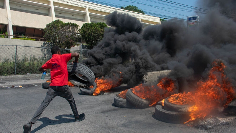 A protester burns tyres following Prime Minister Ariel Henry's announcement that he would quit