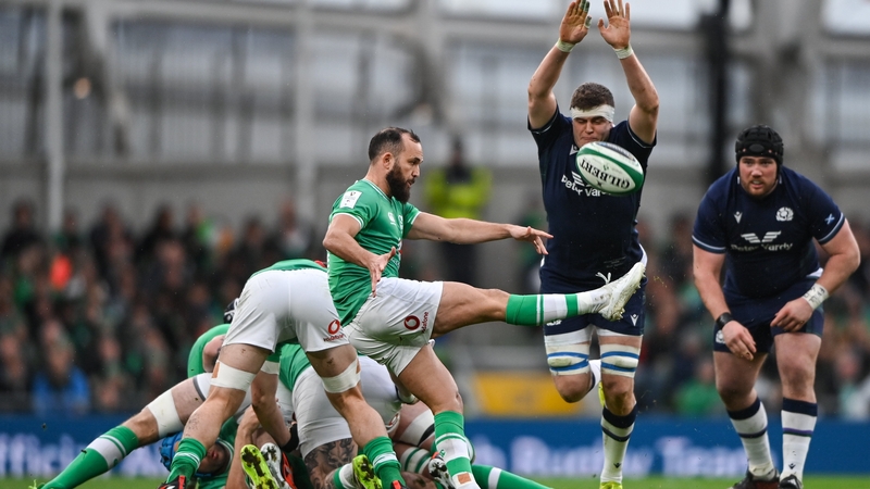 Jamison Gibson-Park of Ireland has a kick charged down by Scott Cummings