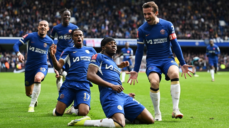 The headbanded Noni Madueke celebrates scoring Chelsea's fourth goal