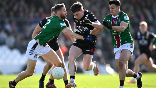 Kevin Maguire and David Lynch of Westmeath attempt to halt the run of Down's Ceilum Doherty