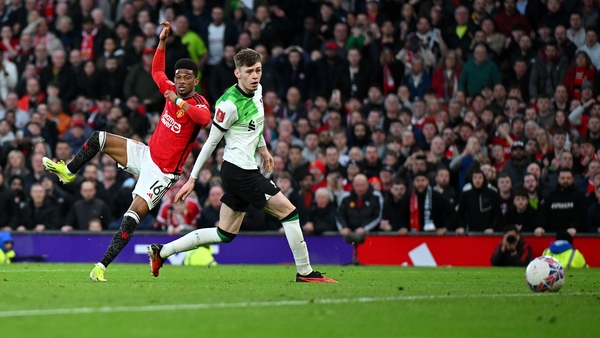 Amad Diallo finishes off a Manchester United counter-attack despite the attentions of Conor Bradley