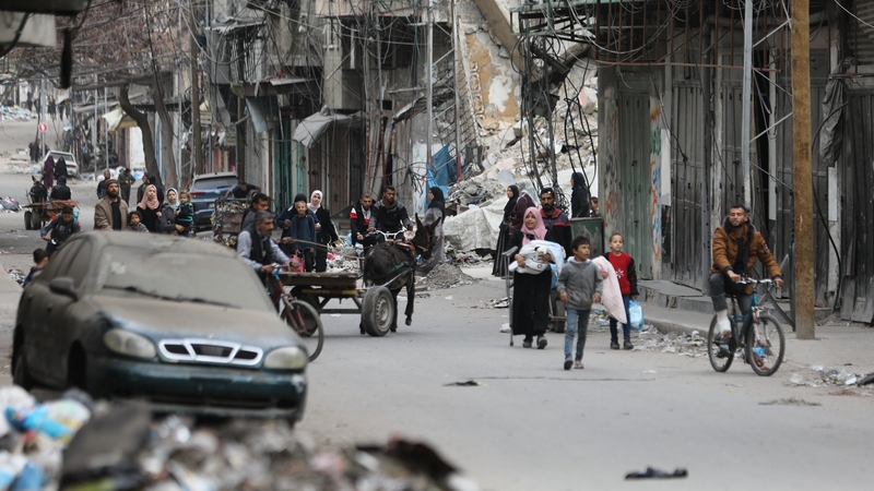 Palestinian residents leave the area with a few items after the Israeli army forces besiege the Al-Shifa hospital with tanks and heavy gunfire in Gaza City