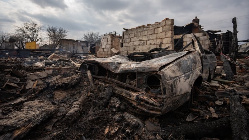 The wreckage of a car is seen amid rubble and debris at a house destroyed by Russian shelling in Makyshyn