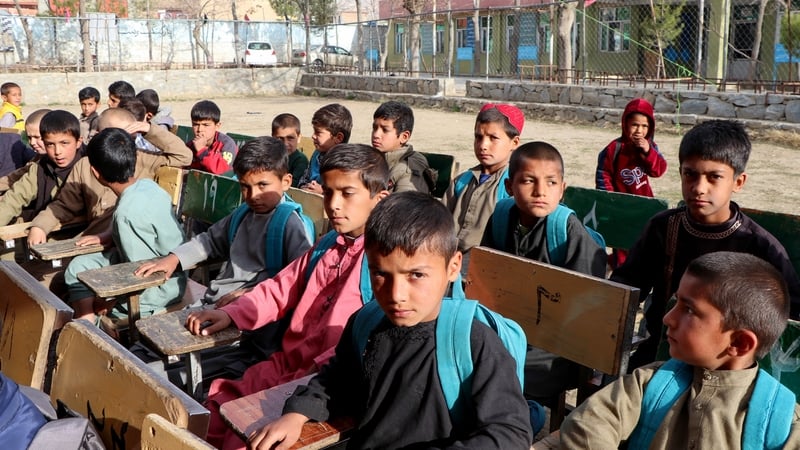 Boys attend their first class following the start of the new academic year, at a school in Charikar city of Parwan province