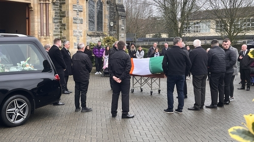 His coffin was covered in the tricolour and a black beret and gloves were placed on top