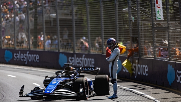 Alex Albon stands by his Williams car after crashing out during the first practice session