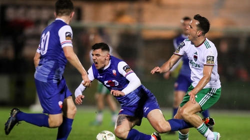 Enda Curran of Treaty United is tackled by Cork City's Charlie Lyons