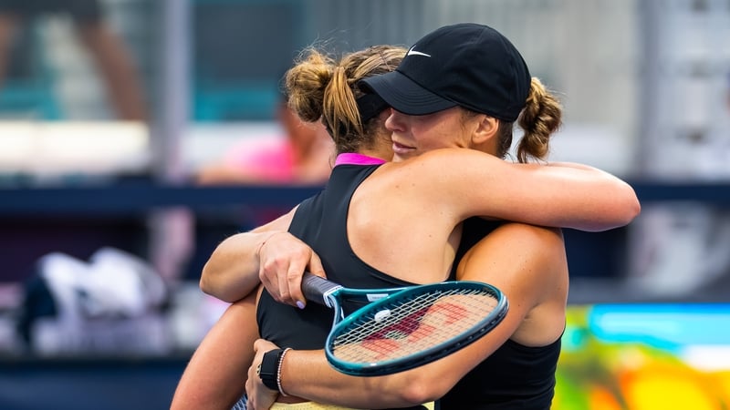 Paula Badosa (L) of Spain and Aryna Sabalenka embrace at the net