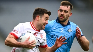 Darren McCurry of Tyrone (L) is tackled by Dublin's Seán MacMahon