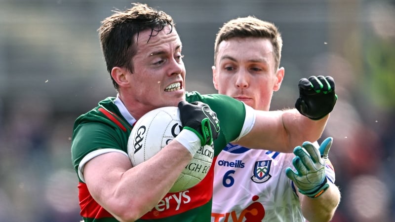 Stephen Coen of Mayo in action against Killian Lavelle