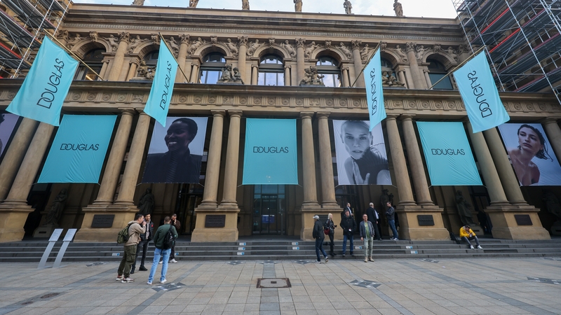 Banners featuring the Douglas logo outside the Frankfurt Stock Exchange