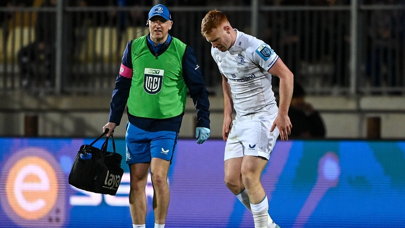 Ciarán Frawley is helped off the field against Zebre by Leinster physio Garreth Farrell
