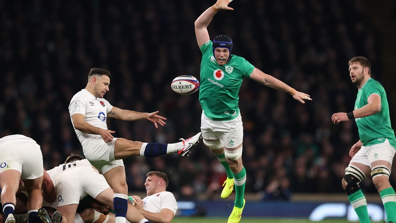 Danny Care kicks away possession, under pressure from Ireland's Ryan Baird, on his 100th appearance for his country earlier this month