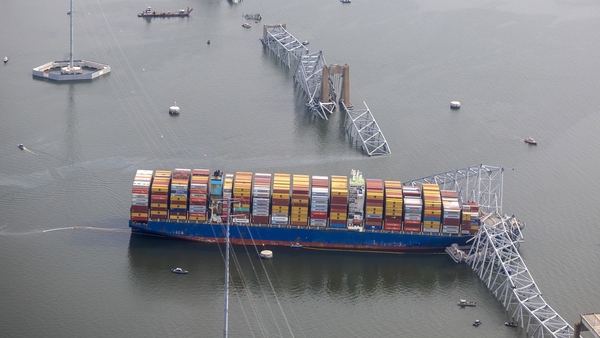 The concrete pylons that supported the main span of the bridge jut from the water like a few broken fence posts