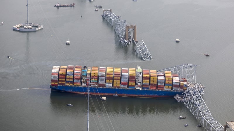 The concrete pylons that supported the main span of the bridge jut from the water like a few broken fence posts