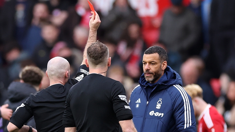 Referee Paul Tierney (L) shows Steven Reid (R) a red card