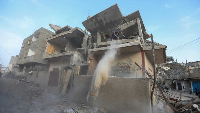 People inspect damage on their homes following an Israeli airstrike on Gaza