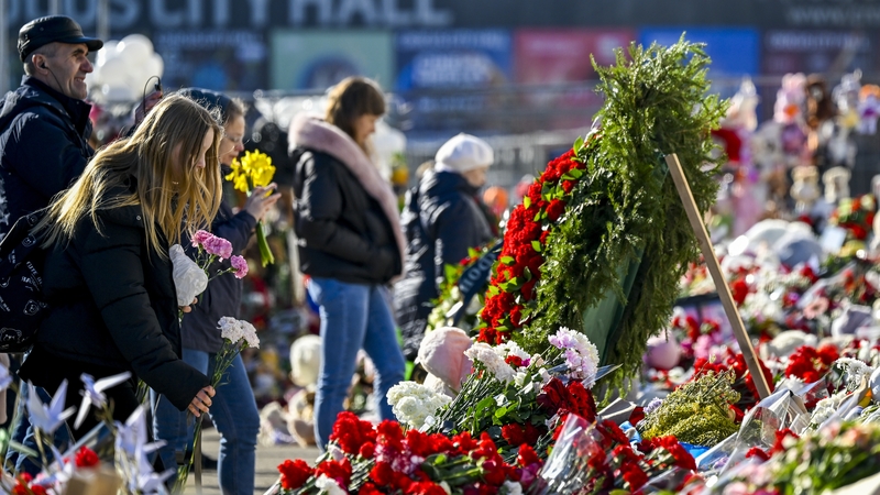 People lay flowers in front of the Crocus City Hall in memory of the victims of the terrorist attack last week
