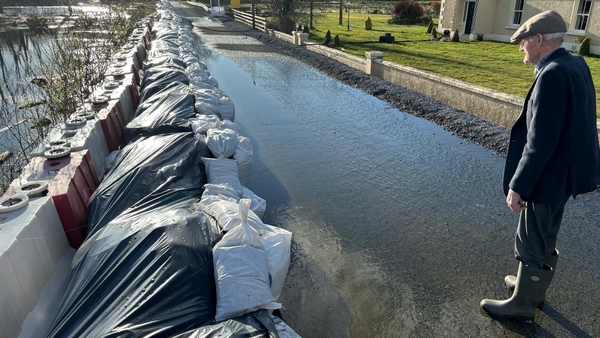 85-year-old Edward John Beattie monitoring water seeping through sandbags