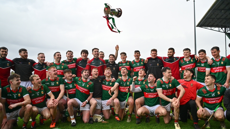 Mayo players and staff celebrate with the cup