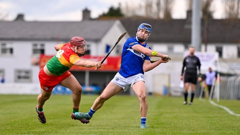 Tomas Keyes of Laois gets a shot away despite the attentions of Carlow's Jack McCullagh