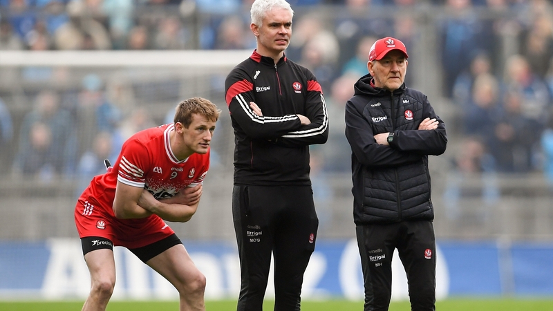 Brendan Rogers (L) watching the penalty shoot-out against Dublin with Derry selector Murtagh O'Brien (C) and manager Mickey Harte