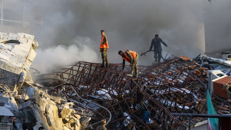 Emergency and security personnel inspect the site of the air strikes