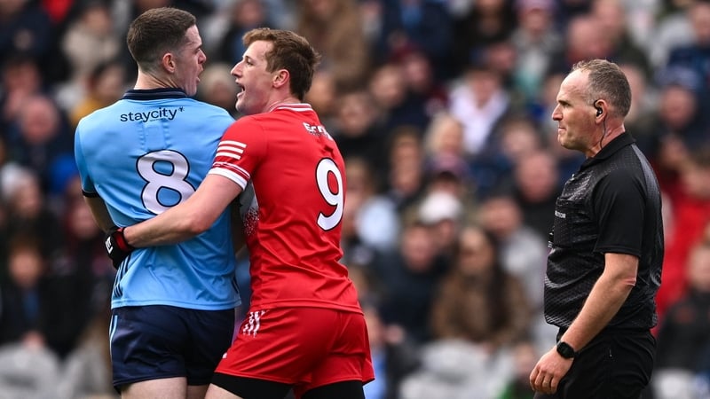 Referee Conor Lane watches on as Brian Fenton and Brendan Rogers grapple during Sunday's Allianz Football Division 1 final