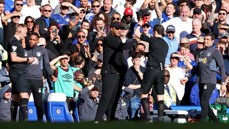 Referee Darren England brandishes a red card at Vincent Kompany at Stamford Bridge