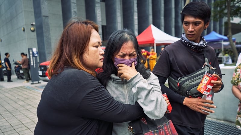 A woman is reunited with her family after being rescued from a hotel in Hualien following the earthquake in Taiwan