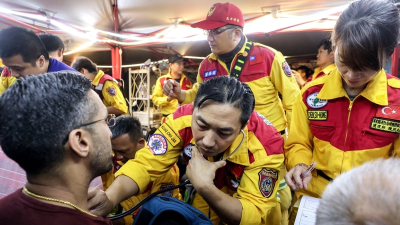 A man receives medical attention at a temporary rescue command post after being rescued from the Taroko National Park in Hualien