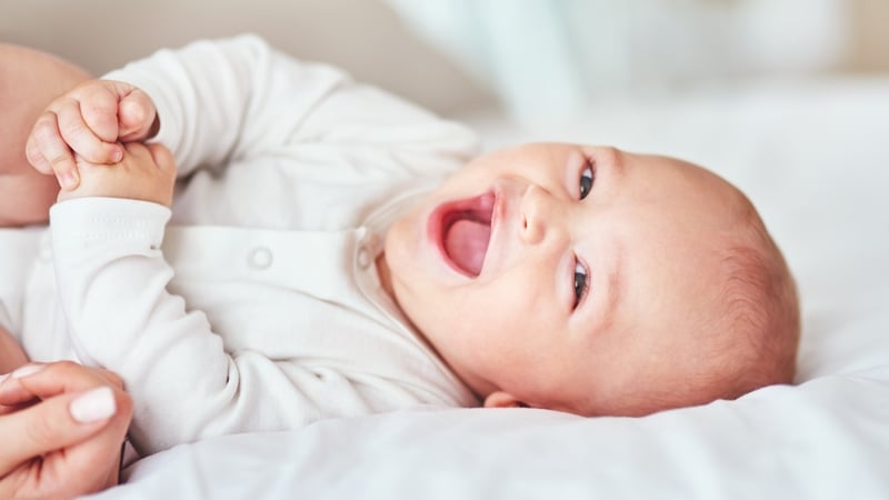 Infants learn to laugh because they want to imitate their parents, and to receive approval from them. Photo: Getty Images