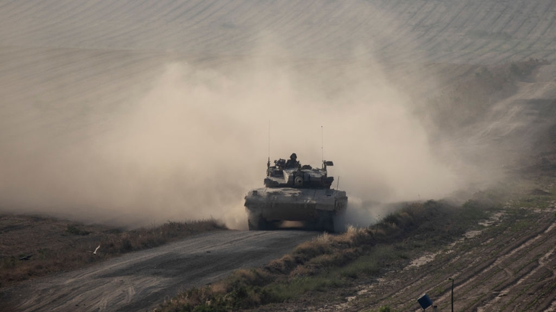 An Israeli tank moves along the border with Gaza
