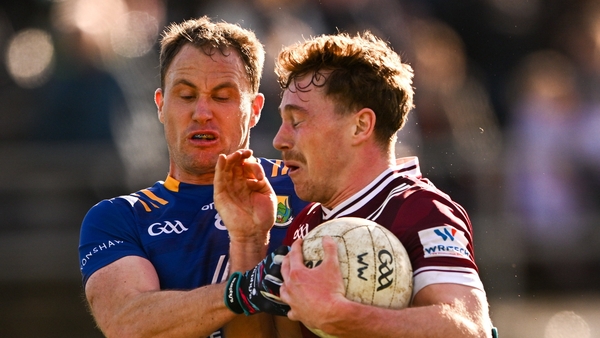 Jonathan Lynam of Westmeath is tackled by Dean Healy of Wicklow