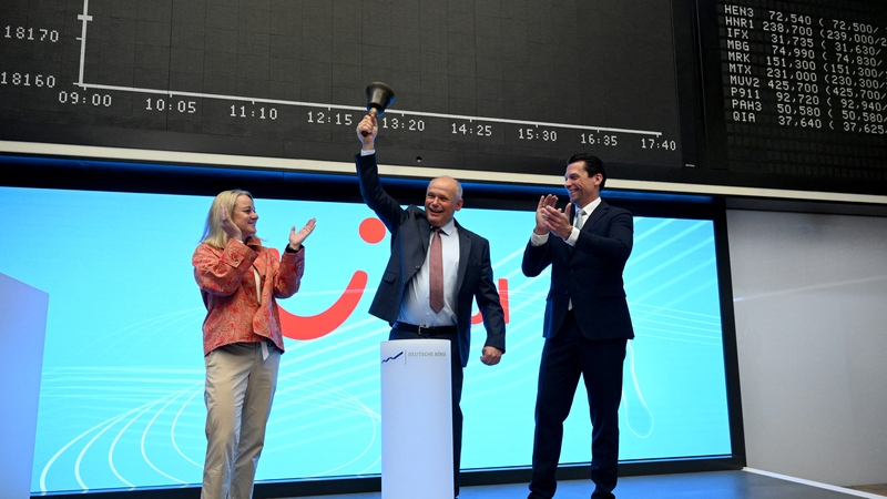 Sebastian Ebel (C), CEO of TUI, rings the bell to start TUI's trading at the Deutsche Boerse stock exchange in Frankfurt, with Nicola Gehrt (L), TUI's Group Director Investor Relations and TUI CFO Mathias Kiep