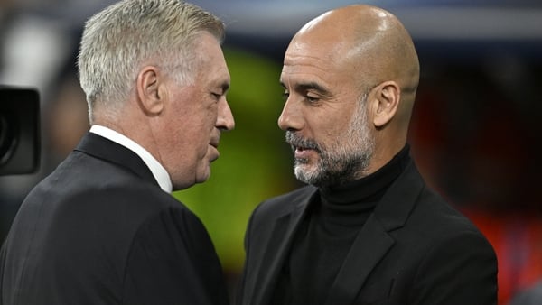 Real Madrid manager Carlo Ancelotti (L) and Man City boss Pep Guardiola