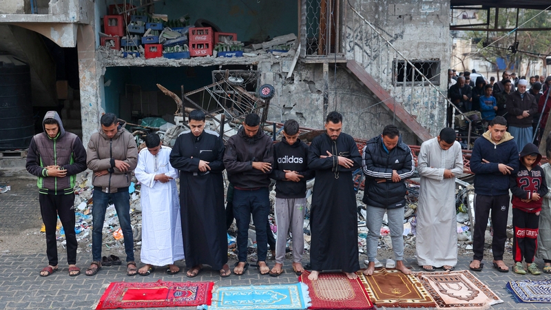 Palestinians offer a special morning prayer to start the Eid al-Fitr festival outside a destroyed mosque in Rafah