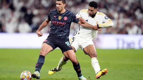 Manchester City's Rodri (L) and Real Madrid's Jude Bellingham battle for the ball during the UEFA Champions League quarter-final