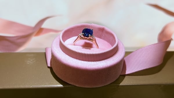 The ring is 1.5 carat blue sapphire and most likely an engagement ring
