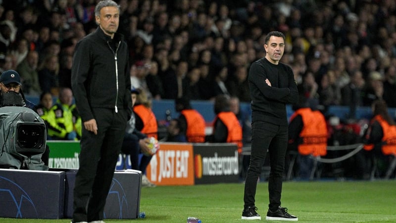 Paris Saint-Germain's Luis Enrique (L) and Barcelona's on the sideline in Paris