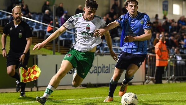 Harry Nevin of Cork City and UCD's Ciaran Behan jostle for possession at Belfield