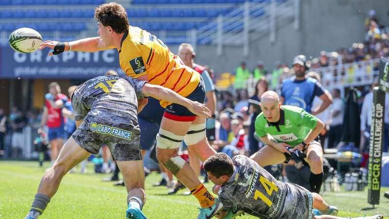 David McCann of Ulster Rugby is tackled by Bautista Delguy and Alex Newsome of Clermont