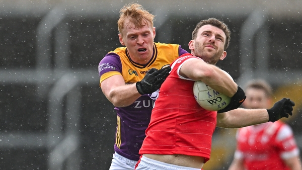Sam Mulroy of Louth in action against Darragh Lyons of Wexford