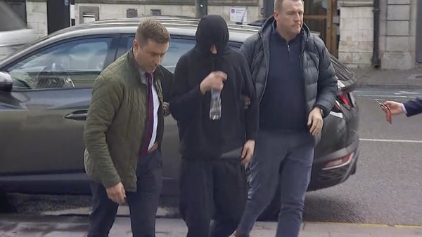 Padraig Delaney (C) was brought before Naas District Court