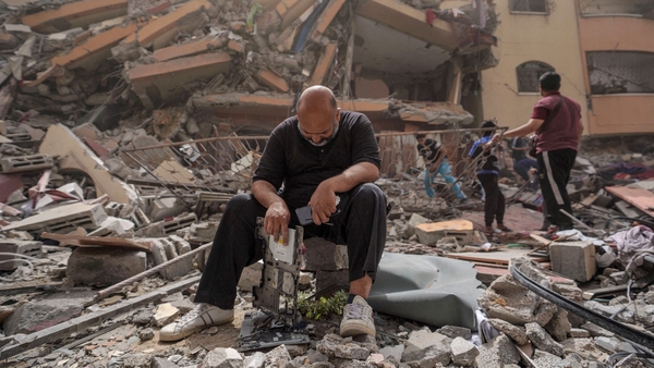 A man inspects damage to a building in the city of Nuseirat in central Gaza