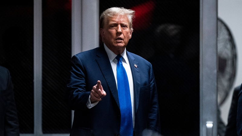 Former US President Donald Trump gestures while he returns to the courtroom for his trial