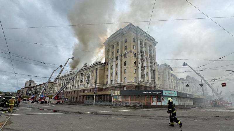 Ukrainian rescuers try to extinguish a fire in a residential building following a missile attack in Dnipro