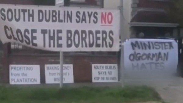A group of protesters wearing masks gathered outside Roderic O'Gorman's home last night